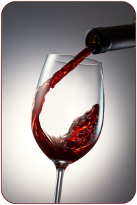Red wine pouring from bottle